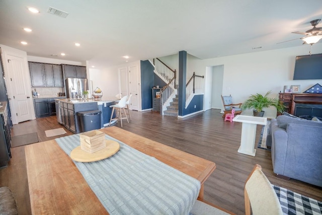 5864 Bianca Dr, Round Rock, TX 78665 - dining room featuring stairway, dark wood-type flooring, recessed lighting, a ceiling fan, and baseboards