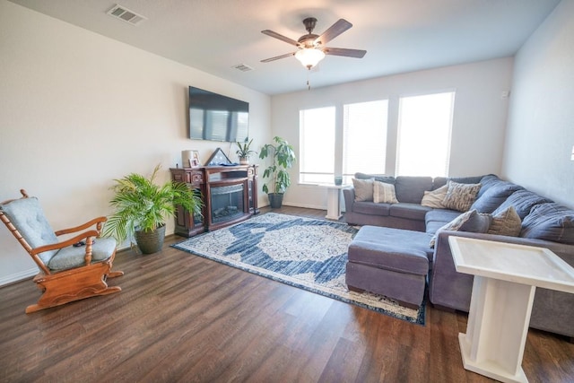 5864 Bianca Dr, Round Rock, TX 78665 - living room featuring a ceiling fan, dark wood-style flooring, a fireplace, and baseboards