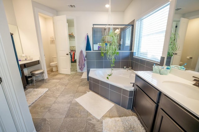 5864 Bianca Dr, Round Rock, TX 78665 - bathroom featuring toilet, a garden tub, vanity, and baseboards