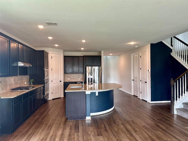 5864 Bianca Dr, Round Rock, TX 78665 - kitchen featuring stainless steel appliances, dark wood-style floors, light stone counters, backsplash, and recessed lighting