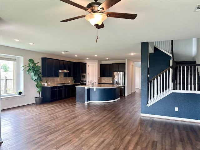 5864 Bianca Dr, Round Rock, TX 78665 - kitchen with appliances with stainless steel finishes, dark wood-style floors, light countertops, decorative backsplash, and recessed lighting