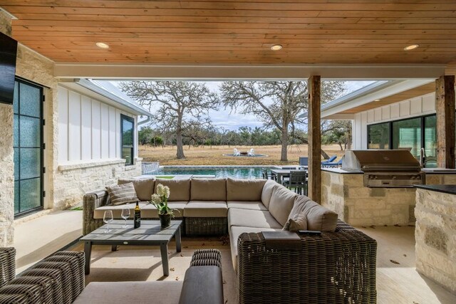 view of patio featuring grilling area, outdoor lounge area, and exterior kitchen