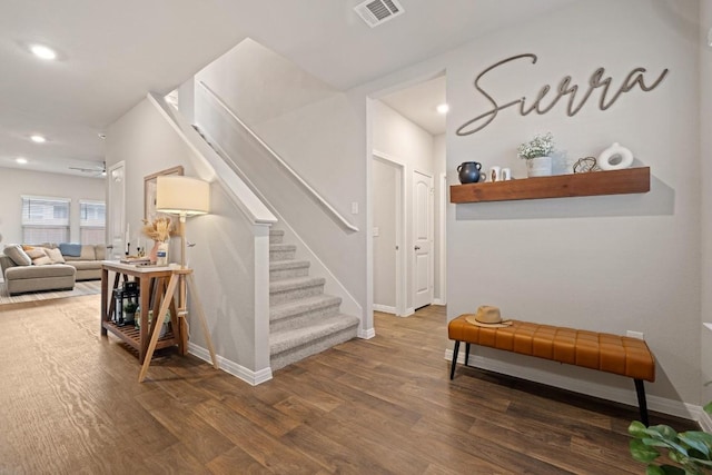 staircase featuring recessed lighting, visible vents, baseboards, and wood finished floors
