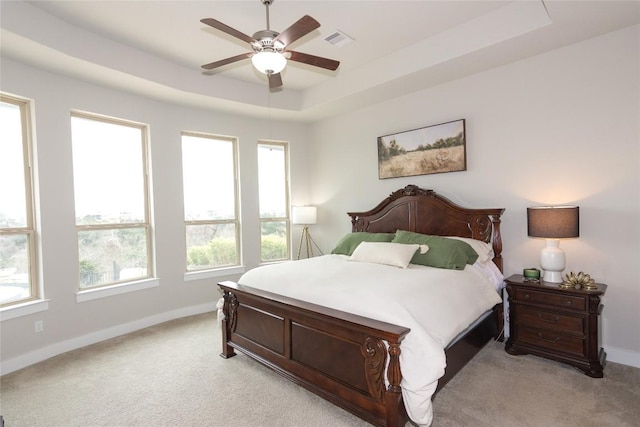 2617 Long Lasso Pass, Leander, TX 78641 - bedroom featuring light colored carpet, baseboards, a raised ceiling, and ceiling fan