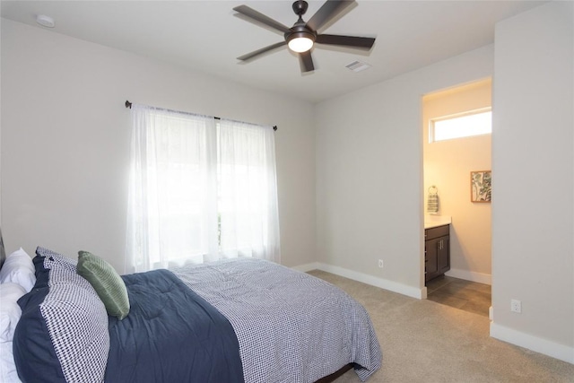 2617 Long Lasso Pass, Leander, TX 78641 - bedroom featuring light colored carpet, baseboards, ensuite bath, and ceiling fan