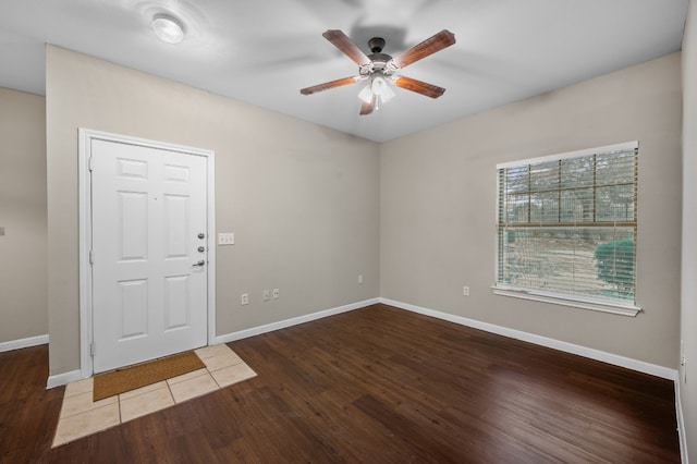 foyer featuring ceiling fan, wood finished floors, and baseboards