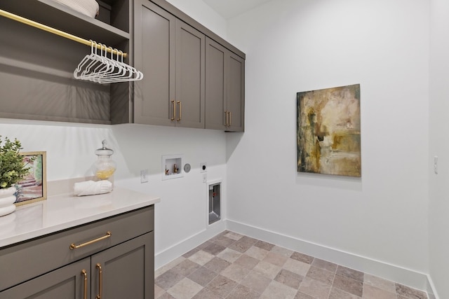 laundry area featuring hookup for a gas dryer, washer hookup, baseboards, cabinet space, and electric dryer hookup