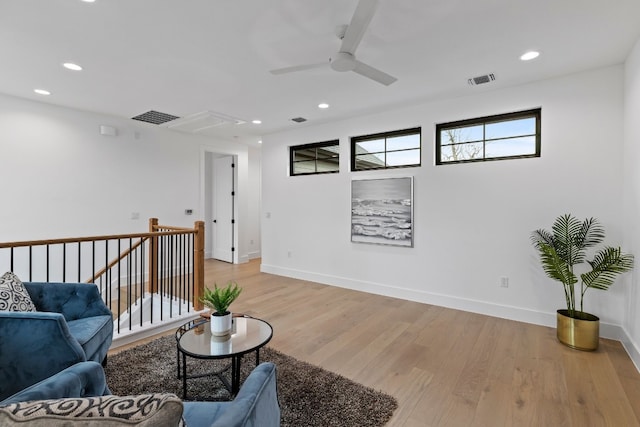 living area with attic access, visible vents, an upstairs landing, light wood-type flooring, and recessed lighting