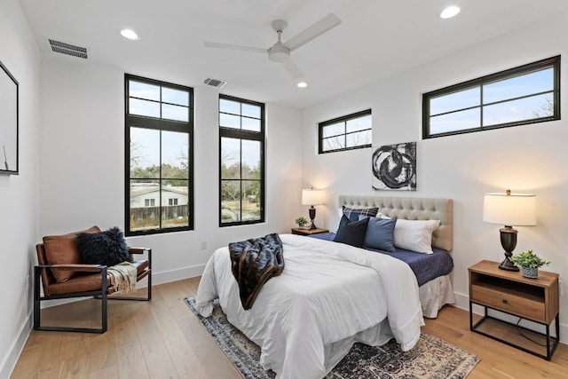 bedroom with light wood-type flooring, visible vents, and recessed lighting