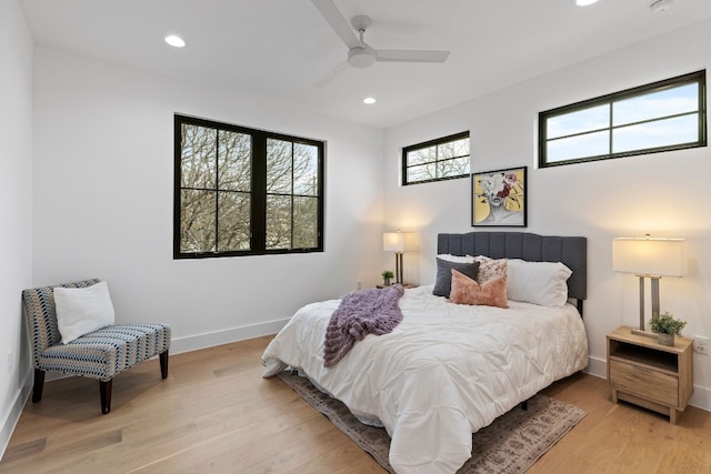 bedroom with recessed lighting, light wood-type flooring, and baseboards