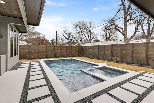 view of pool featuring a fenced backyard and a pool with connected hot tub