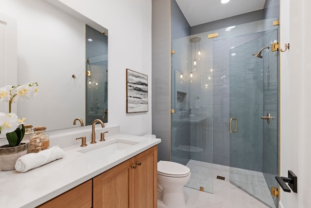 full bath featuring toilet, a shower stall, and vanity