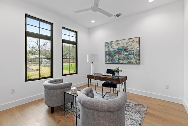 office with light wood finished floors, visible vents, and baseboards