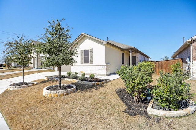 1011 Moose Rd, Hutto, TX 78634 - view of front facade featuring stone siding, stucco siding, and driveway
