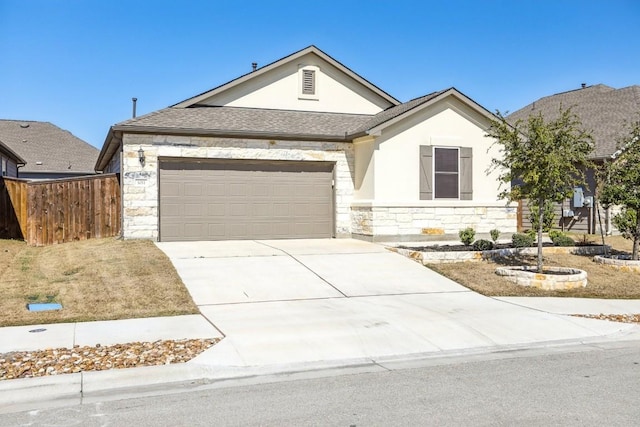 1011 Moose Rd, Hutto, TX 78634 - view of front of property with stone siding, a garage, concrete driveway, and stucco siding