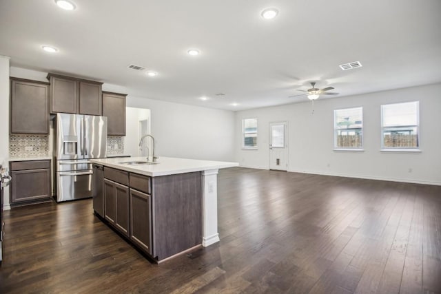 1011 Moose Rd, Hutto, TX 78634 - kitchen with stainless steel appliances, ceiling fan, open floor plan, a sink, and light countertops