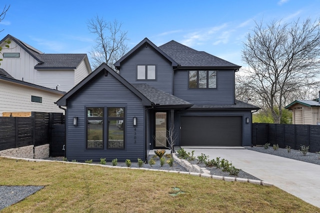 view of front of house featuring a shingled roof, a front yard, fence, a garage, and driveway