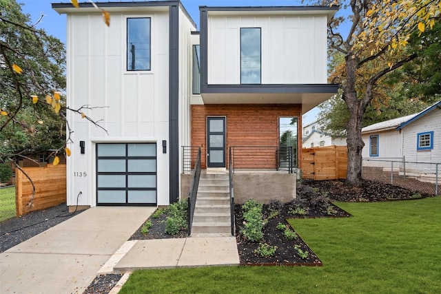 1135 Salina St, Austin, TX 78702 - modern home with board and batten siding, an attached garage, concrete driveway, and covered porch