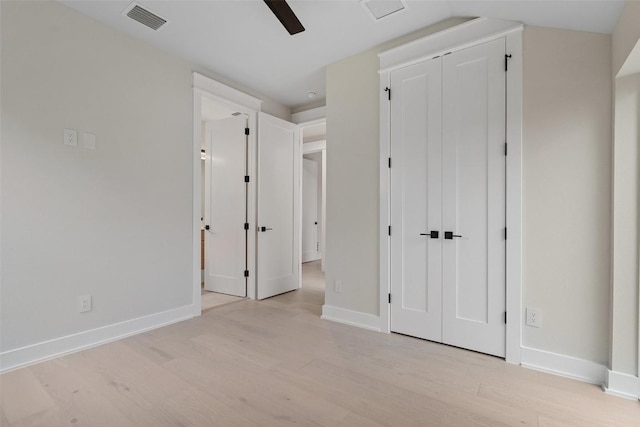 1135 Salina St, Austin, TX 78702 - unfurnished bedroom featuring light wood-type flooring, baseboards, a closet, and ceiling fan