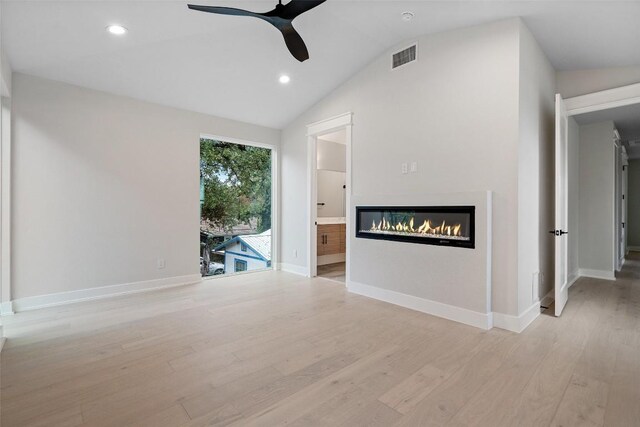 1135 Salina St, Austin, TX 78702 - unfurnished living room featuring a ceiling fan, light wood-style flooring, a glass covered fireplace, recessed lighting, and baseboards