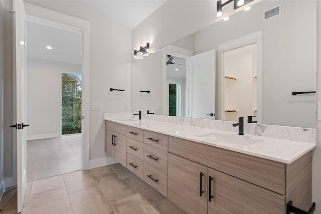 1135 Salina St, Austin, TX 78702 - bathroom featuring double vanity, baseboards, and recessed lighting