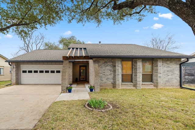 view of front of home featuring a garage, driveway, roof with shingles, and a front yard