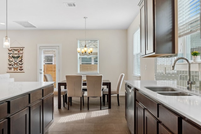 dining space with visible vents, a notable chandelier, and dark tile patterned floors