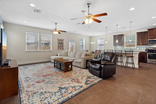 living area with baseboards, visible vents, a ceiling fan, and recessed lighting