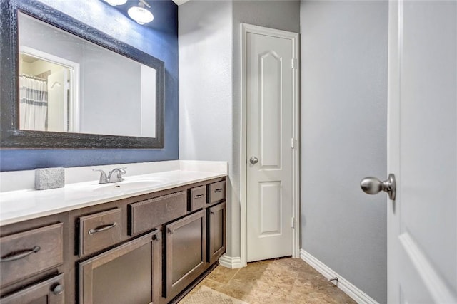 bathroom with baseboards and vanity