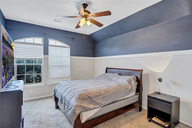 bedroom featuring visible vents, light carpet, vaulted ceiling, ceiling fan, and baseboards