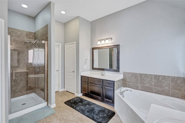 bathroom with a stall shower, tile patterned floors, vanity, and a bath