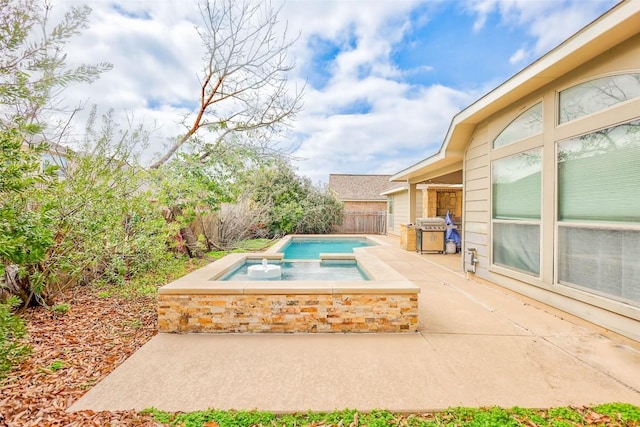 view of pool featuring a patio area, a fenced backyard, area for grilling, and an in ground hot tub