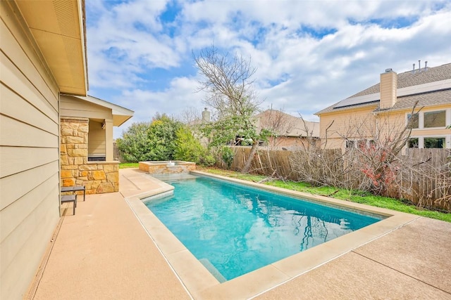 view of swimming pool with a patio area, a fenced backyard, and a pool with connected hot tub