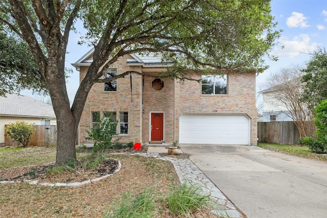 traditional-style home featuring a garage, concrete driveway, brick siding, and fence