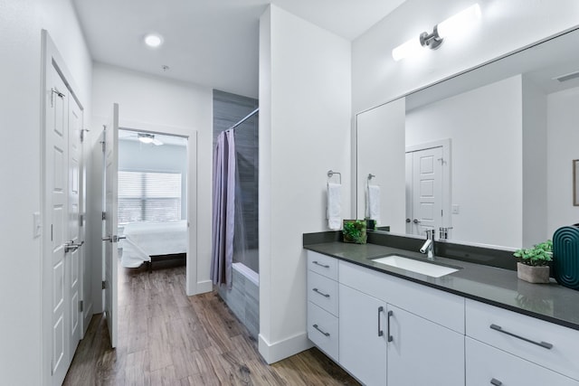 6444 Burnet Rd Unit 308, Austin, TX 78757 - ensuite bathroom with vanity, wood finished floors, shower / bath combo, and recessed lighting