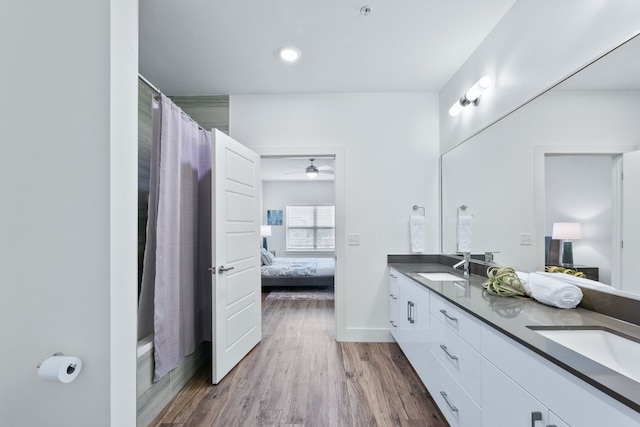 6444 Burnet Rd Unit 308, Austin, TX 78757 - bathroom with ensuite bathroom, double vanity, wood finished floors, a ceiling fan, and curtained shower