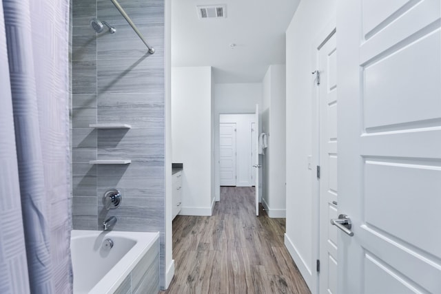 6444 Burnet Rd Unit 308, Austin, TX 78757 - bathroom featuring shower / tub combo and wood finished floors