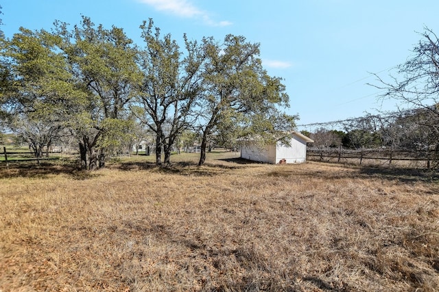 view of yard with a rural view and fence