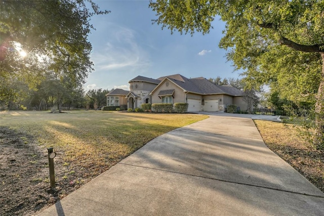 view of front facade with an attached garage, a front lawn, and concrete driveway