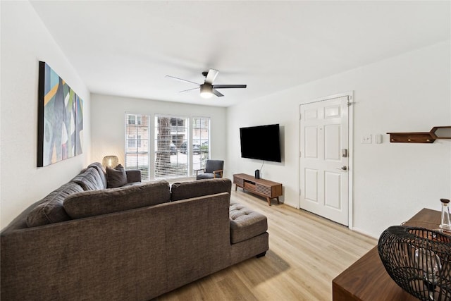 living room featuring light wood-type flooring and a ceiling fan