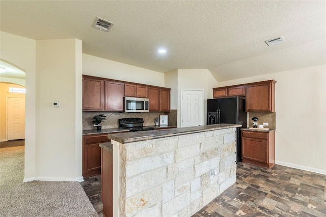 214 Teron Dr, San Marcos, TX 78666 - kitchen featuring baseboards, arched walkways, black appliances, backsplash, and a kitchen island