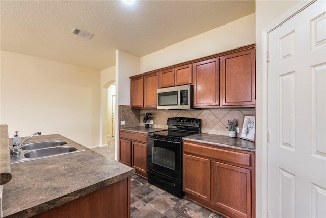 214 Teron Dr, San Marcos, TX 78666 - kitchen with visible vents, a sink, dark countertops, black / electric stove, and stainless steel microwave
