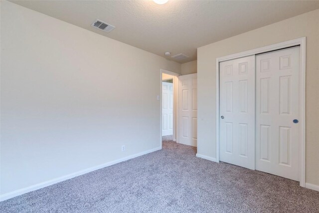 214 Teron Dr, San Marcos, TX 78666 - unfurnished bedroom with visible vents, baseboards, and carpet floors