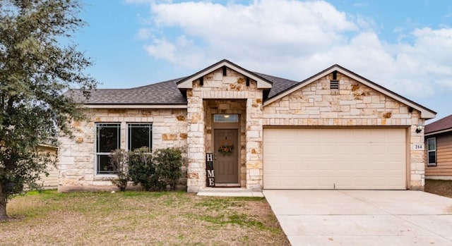 214 Teron Dr, San Marcos, TX 78666 - view of front of home with roof with shingles, stone siding, and an attached garage
