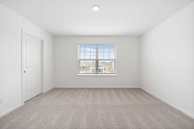 carpeted spare room with baseboards