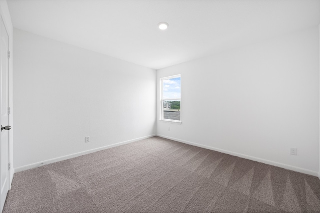 carpeted empty room with baseboards