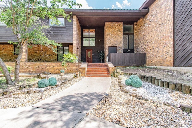 doorway to property with brick siding