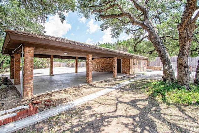 exterior space featuring fence and a carport