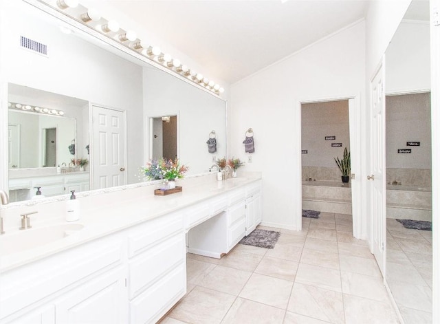 full bathroom featuring a garden tub, a sink, visible vents, vaulted ceiling, and double vanity