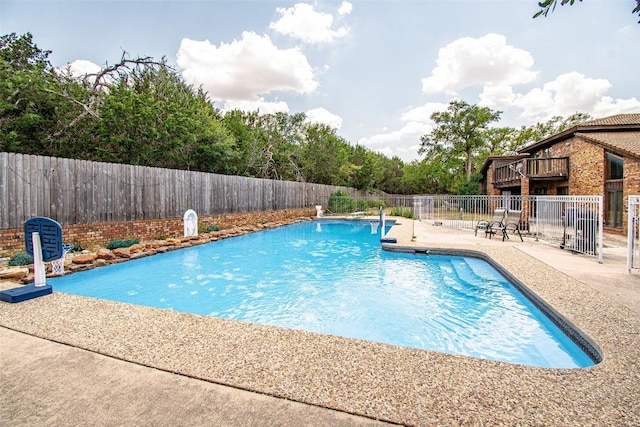 view of swimming pool with a patio area, a fenced backyard, and a fenced in pool